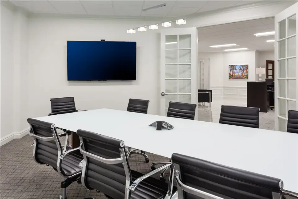A conference room in The Suites at 231, with a TV mounted on the wall.